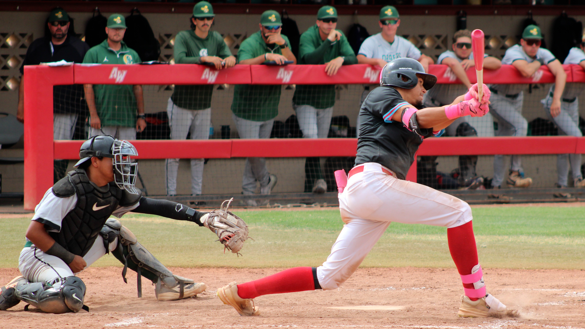 Jamie Beerman swings and misses against Central Arizona. Photo by Shayden Aguigui